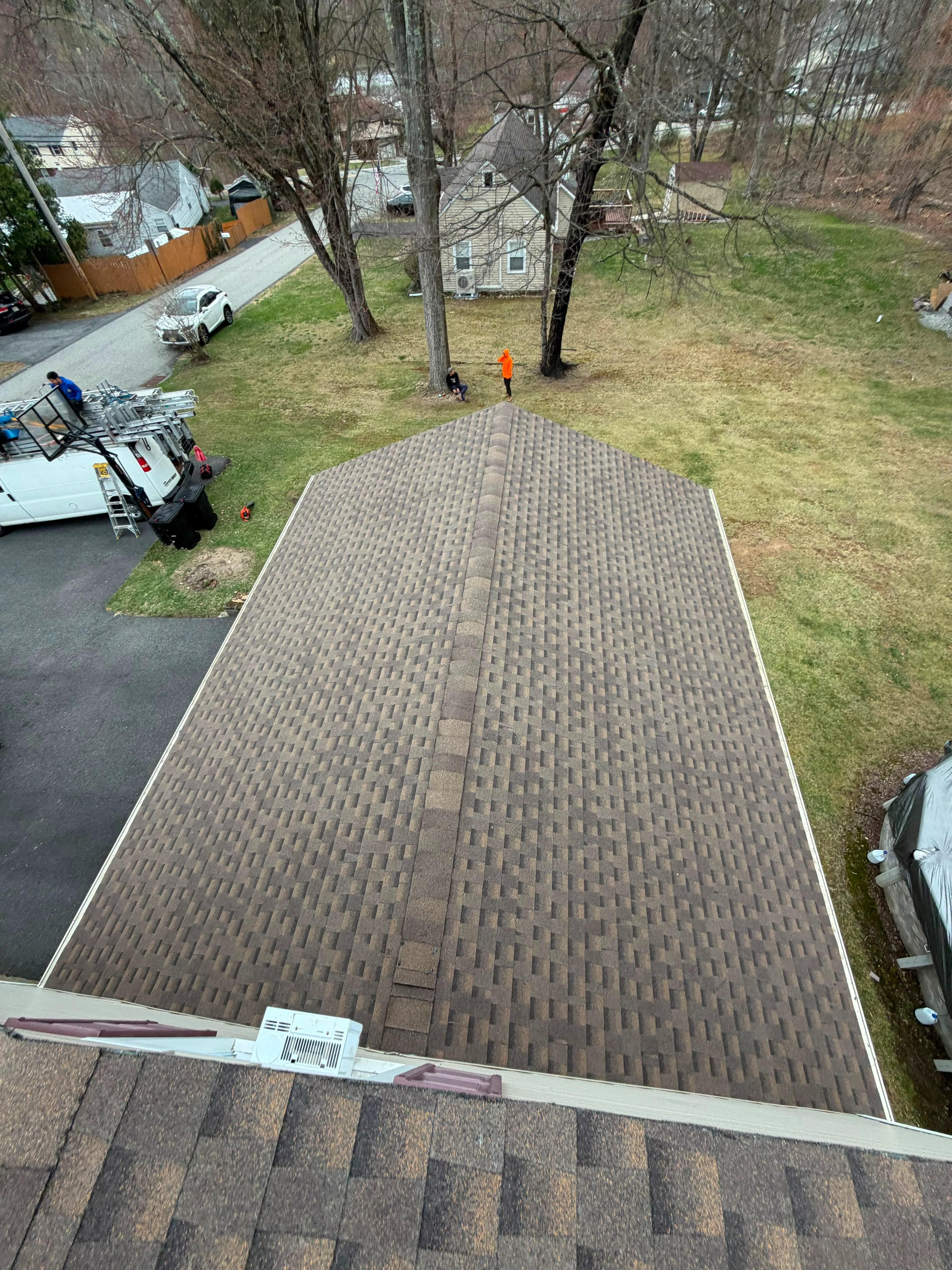 Restored asphalt shingle roof with clean lines and uniform coverage after roof repair in New Jersey